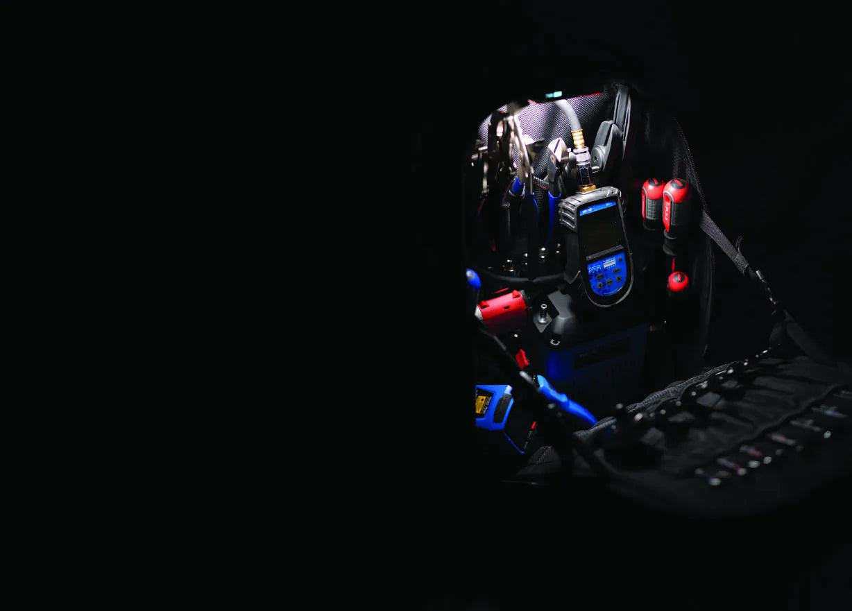 The 3996 opened in low light, loaded with pliers, a digital multimeter, a cordless impact wrench, battery packs and a full socket rail.