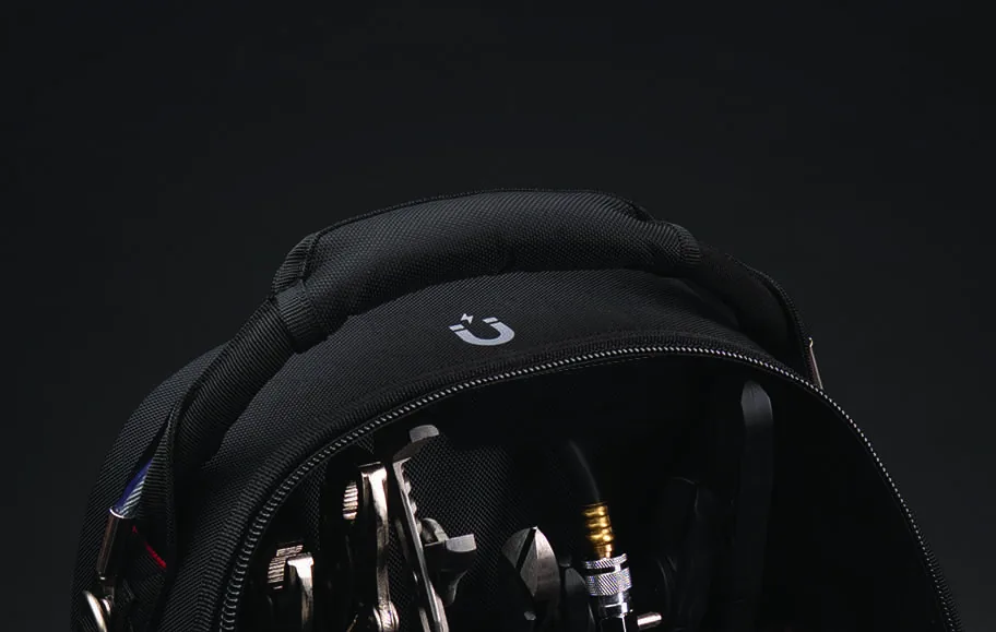 The padded top of the 3996 with a magnet icon, unzipped to reveal wrenches, pliers and a coiled hose inside.