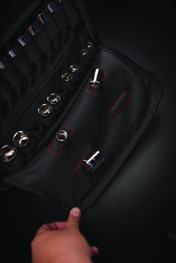 A hand folding open the socket panel, revealing elastic sleeves that hold each 1/2 inch drive socket separately.